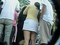 The chick was too curious to stop near the crowd and see what was going on there, and I managed record her upskirt ass!